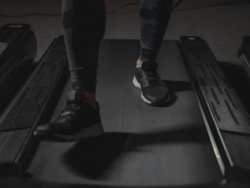 Person focusing on their movement in a stylized dark gym